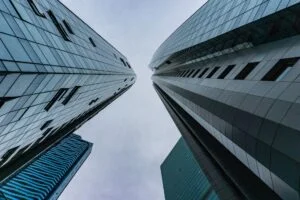 Depicts several high rise buildings as viewed from the ground. Used as a cover image for an article about investment platforms raising funds through equity crowdfunding.