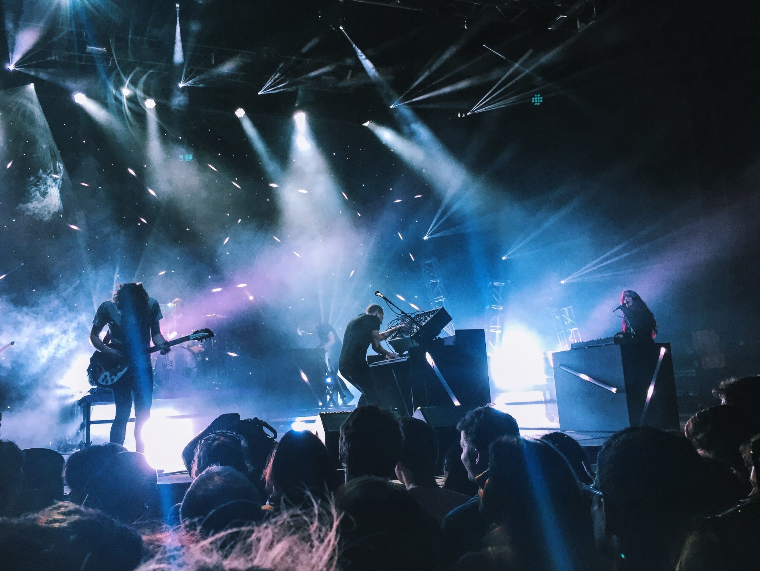 Image depicts a band playing onstage. Used as a cover photo for an article overview of ANote Music. ANote Music is a music royalty investing platform based out of the EU.