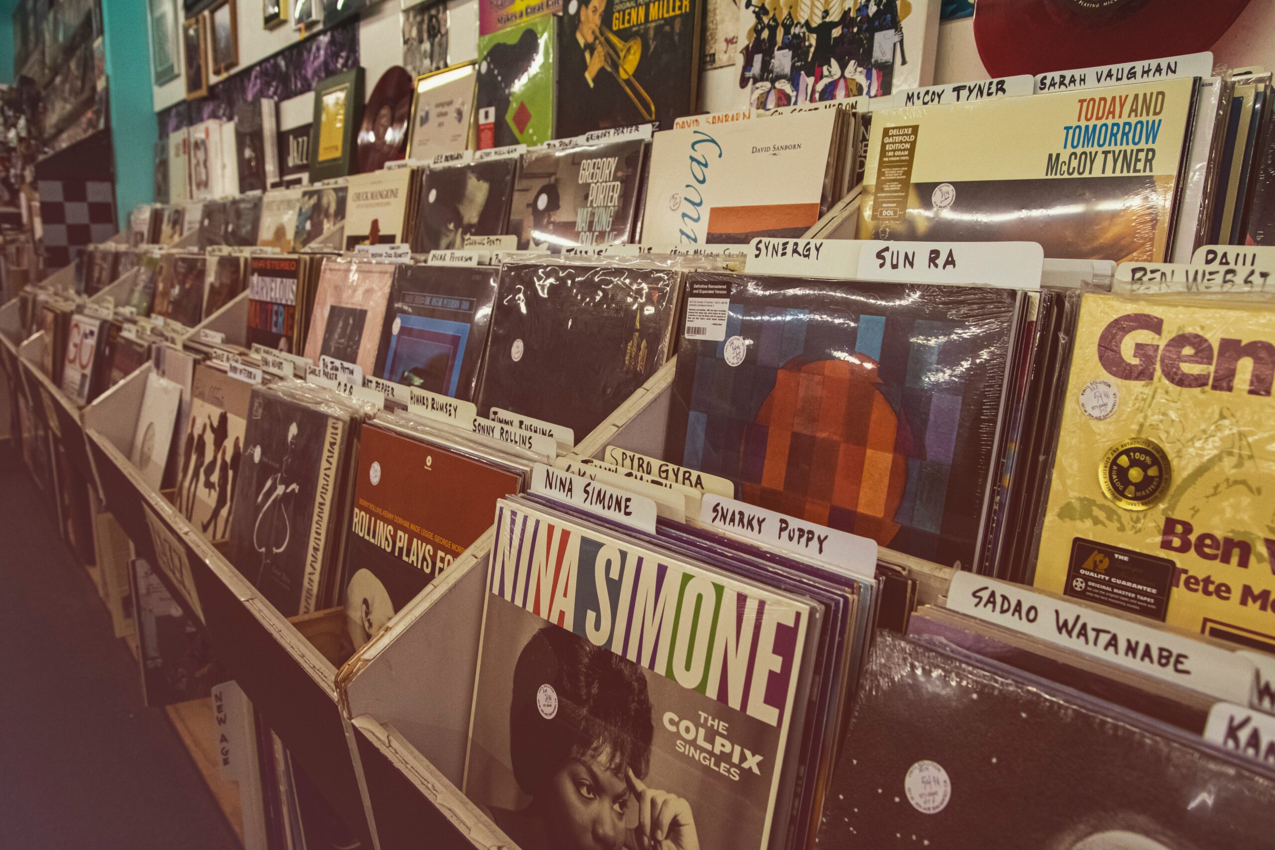 Depicts a record store - various records are organized into boxes and layered onto shelves. Used as a cover image for an overview article about Royalty Exchange.