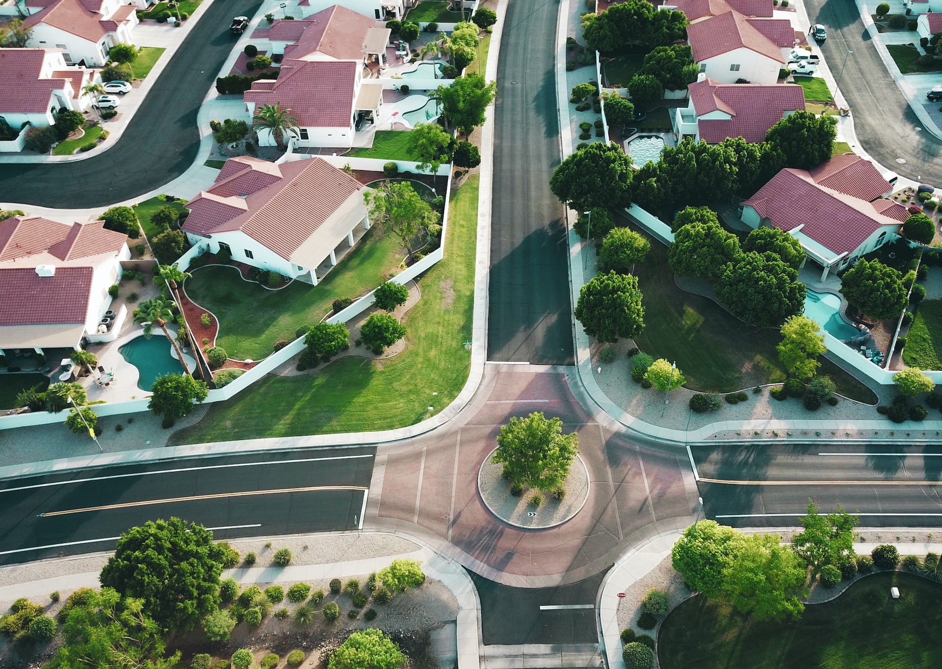 Depicts a community of single family homes as seen from drone height. Used to represent real estate as an alternative investment.