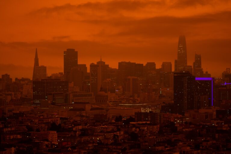 Depicts San Francisco from a distance with an orange colored sky. Used as a cover image for an article tracking the Silicon Valley Bank fallout amongst alternative investment platforms.