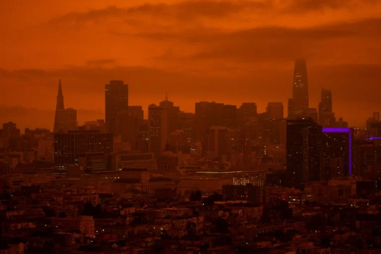 Depicts San Francisco from a distance with an orange colored sky. Used as a cover image for an article tracking the Silicon Valley Bank fallout amongst alternative investment platforms.