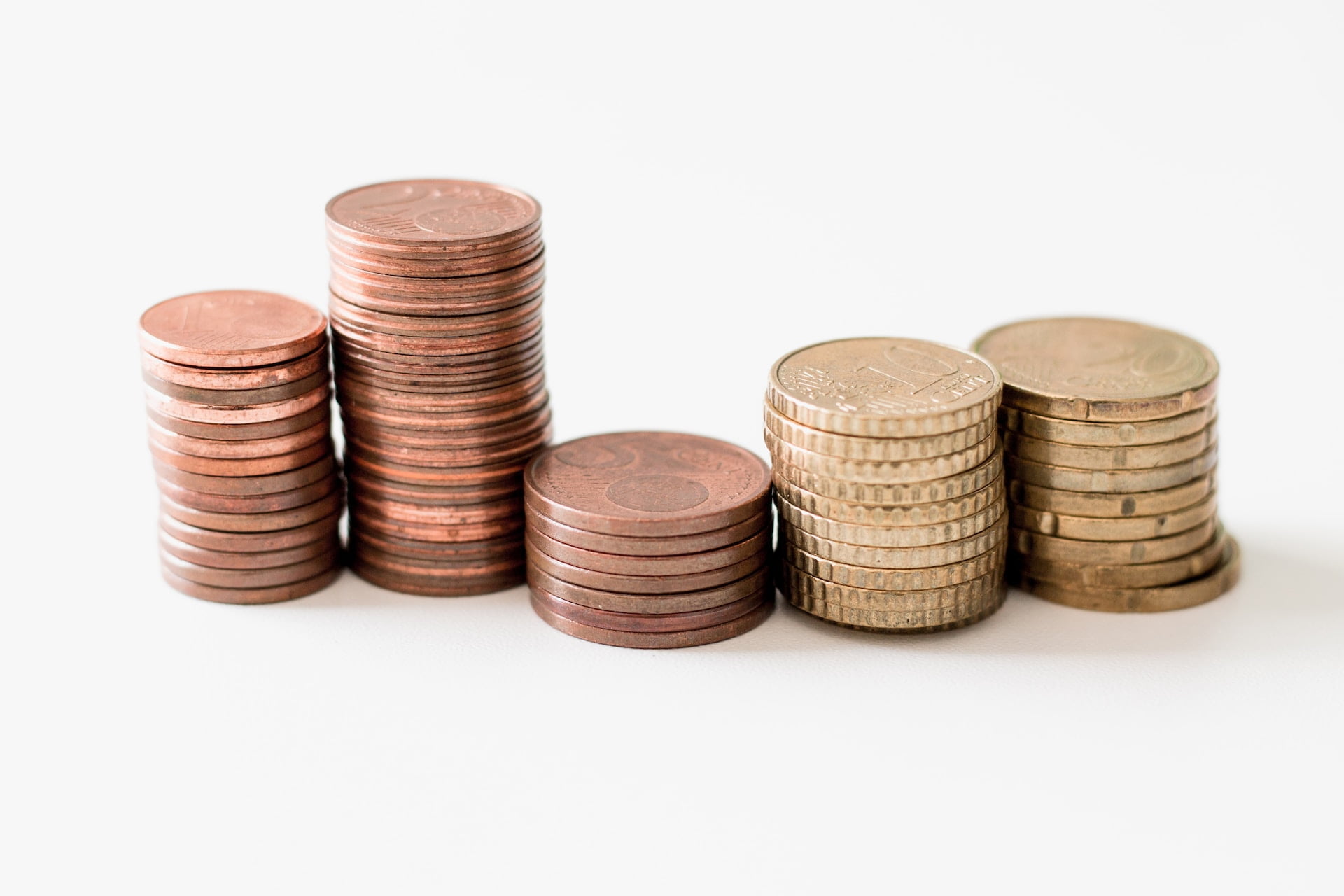 Depicts a few stacks of coins. Used as a cover image in a blog post discussing results from investing in SongVest for one year.